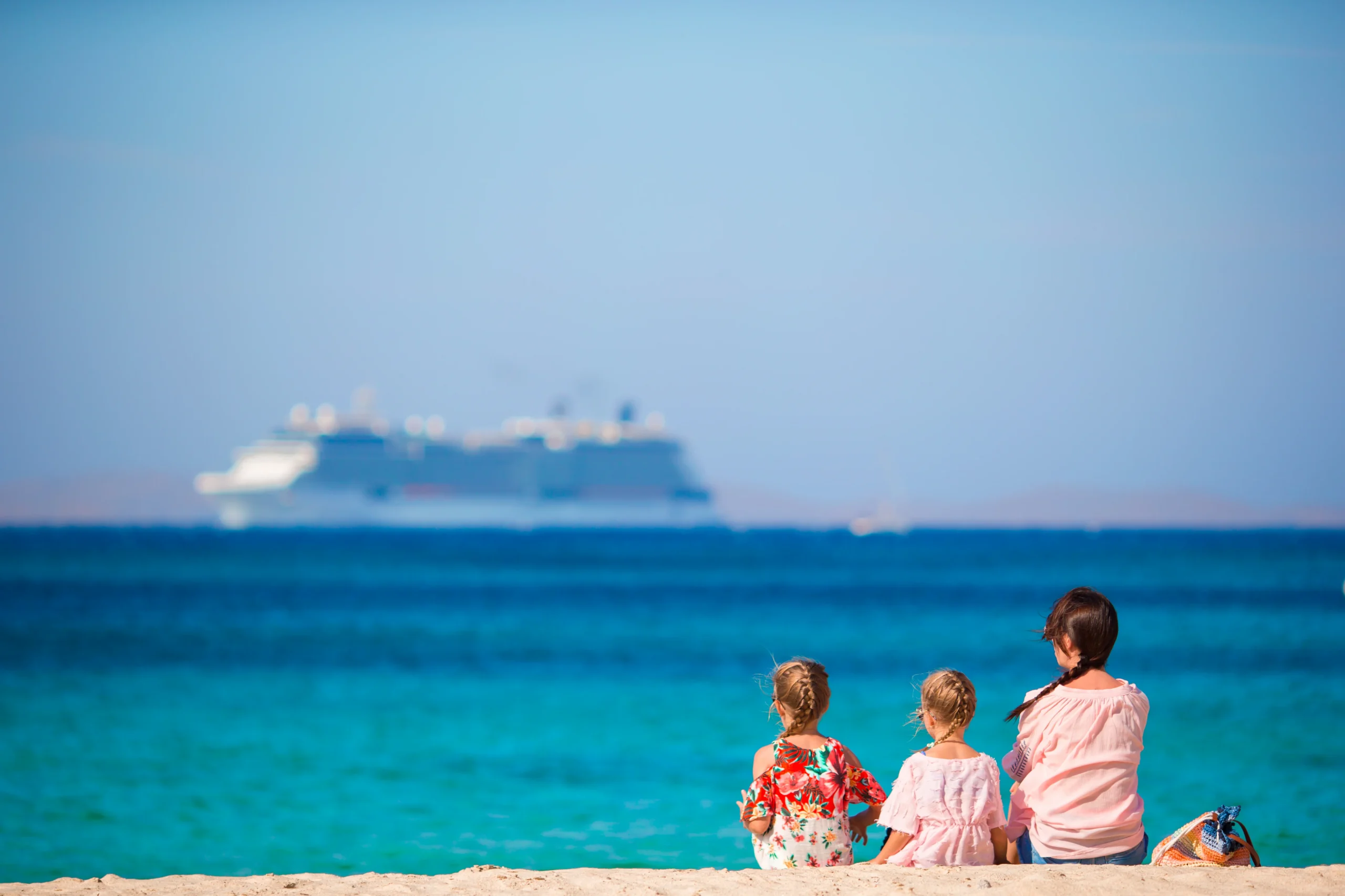 family on the beach relax and looking ar the horizone - Designing the Definitive Galapagos Family Cruise Experience