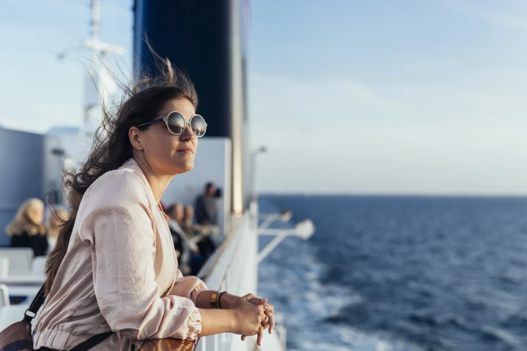 young woman enjoying a boat trip on water - What Are the Advantages of a Tailor-Made Luxury Galapagos Cruise vs. a Traditional Trip?